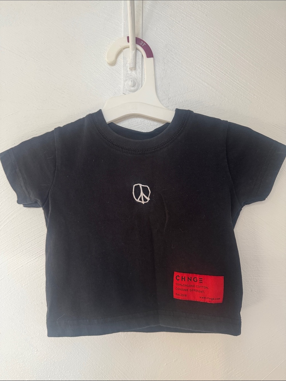 CHNGE Black Tee with White Peace Embroidery and Red Patch